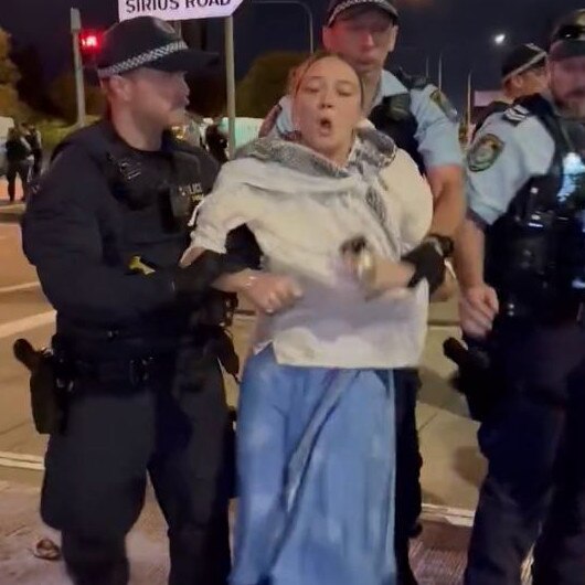 A protester is led away by police last night. Picture Twitter