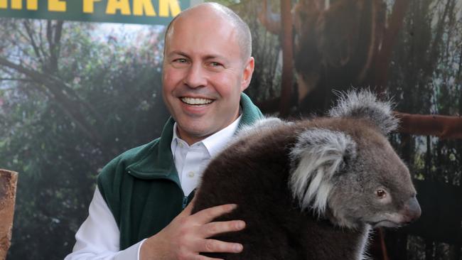 Josh Frydenberg wrangles a koala on a visit to a Perth wildlife park. Picture: Philip Gostelow