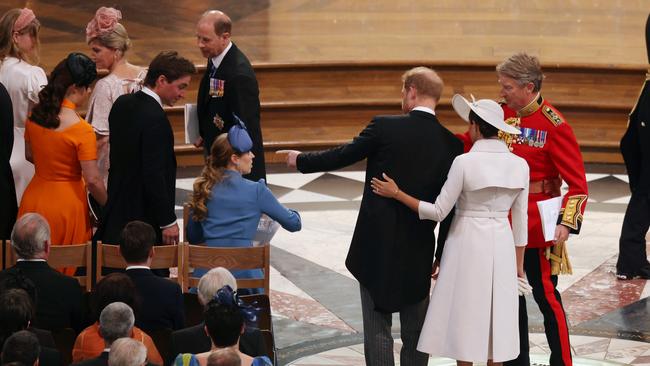 The couple are shown to their seats, several ­metres away from Prince Charles and Camilla, and Prince William and Kate.