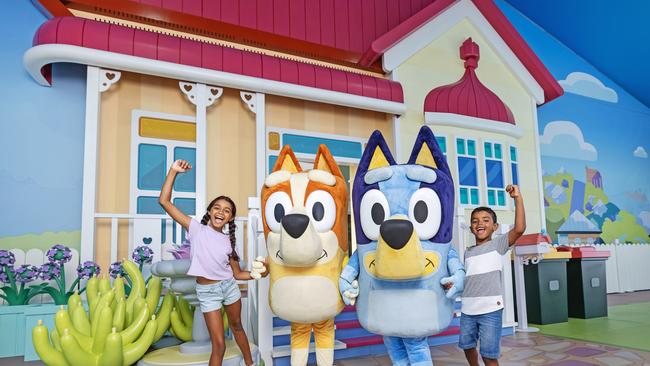 The first glimpse of Bluey's World Brisbane. Fans Madeleine Evans, 10, and Joshua Evans, 7, with Bingo and Bluey.