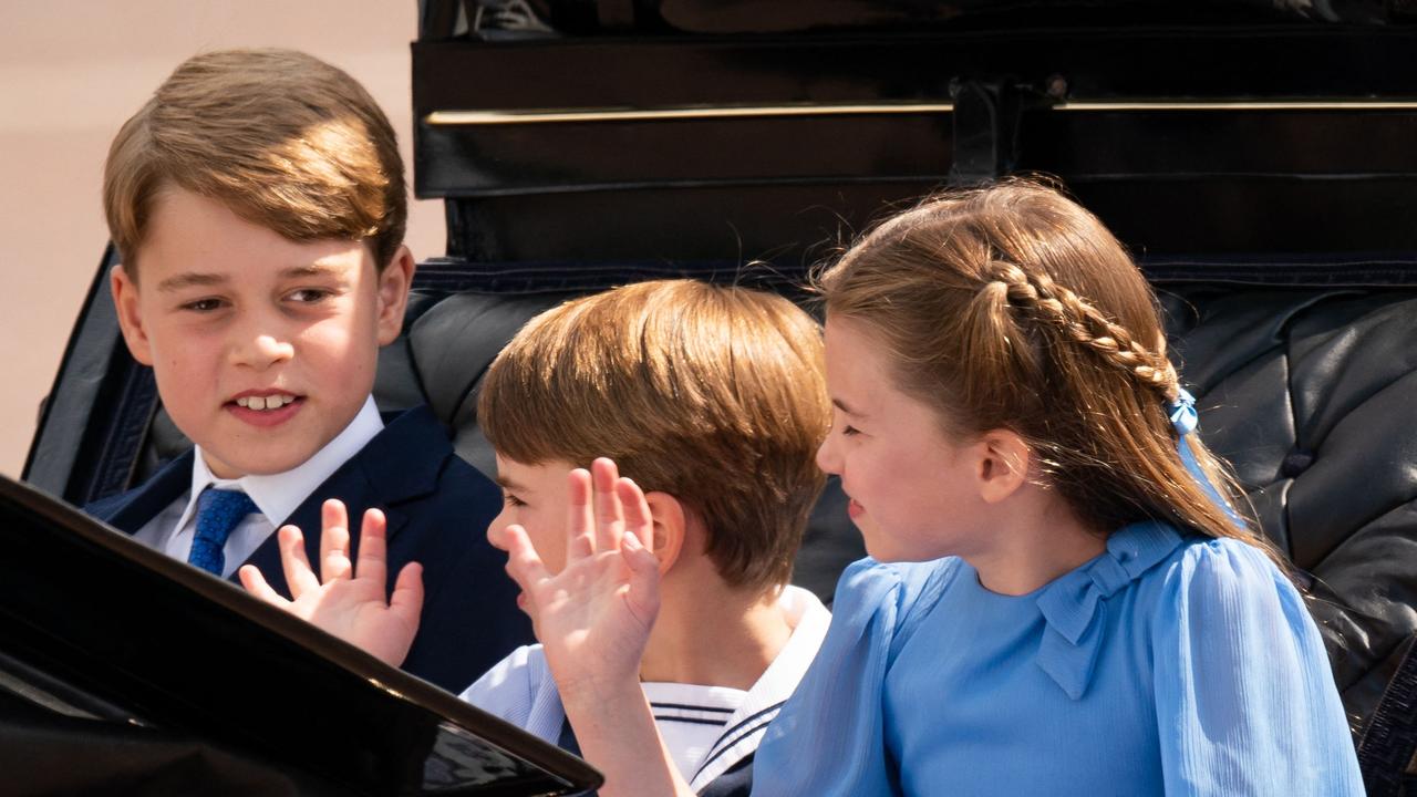 Prince George, Prince Louis and Princess Charlotte, dressed in a light blue, white and navy colour theme, enjoy their first carriage procession, as part of the Trooping the Colour. Picture: AFP