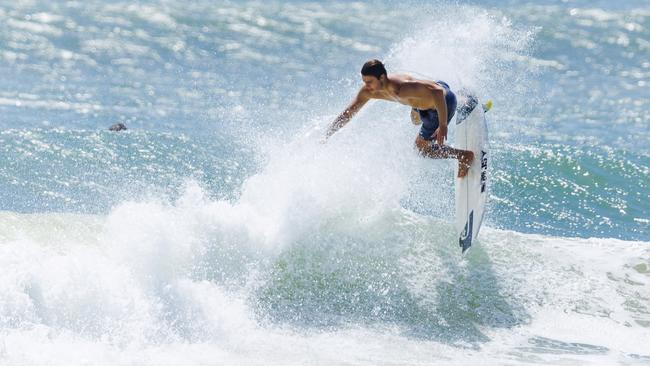 A surfer gets some airtime in the sun at Mooloolaba. Picture: Lachie Millard