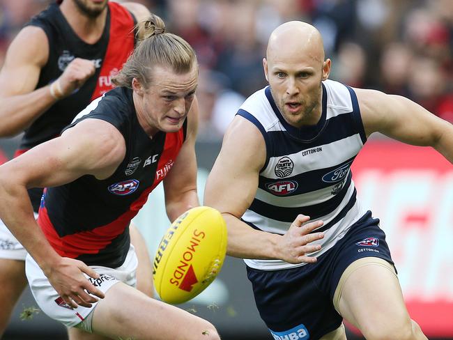 AFL Round 7. 05/05/2019. Geelong v Essendon at the MCG.   Geelongs Gary Ablett  chases the loose footy ahead os Essendon's Mason Redman  and Kyle Langford     . Pic: Michael Klein.