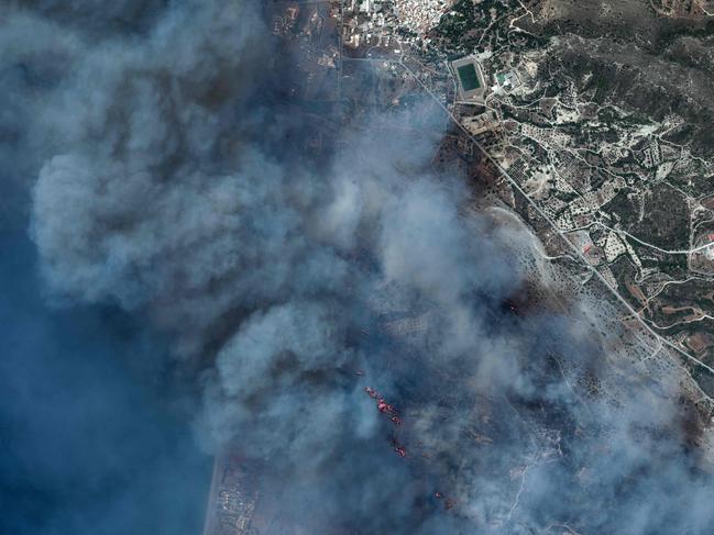 This satellite image taken by Maxar Technologies on July 24, 2023, shows a view of a fire near Gennadi on Rhodes island in Greece. Tens of thousands of people have already fled blazes on the island of Rhodes, with many frightened tourists scrambling to get home. Greece has been sweltering under a lengthy spell of extreme heat that has exacerbated wildfire risk and left visitors stranded in peak tourist season. (Photo by Handout / Satellite image Â©2023 Maxar Technologies / AFP) / RESTRICTED TO EDITORIAL USE - MANDATORY CREDIT "AFP PHOTO / Satellite image Â©2023 Maxar Technologies" - NO MARKETING NO ADVERTISING CAMPAIGNS - DISTRIBUTED AS A SERVICE TO CLIENTS