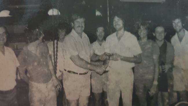 Max Tomlinson presents Tony Raggatt with a pen at the Northern Miner in Charters Towers.