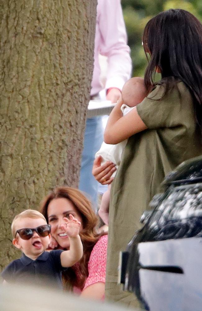 A stylish Prince Louis tries to get the attention of his new cousin, Archie Mountbatten-Windsor at the King Power Royal Charity Polo Match. Picture: Max Mumby/Indigo/Getty Images