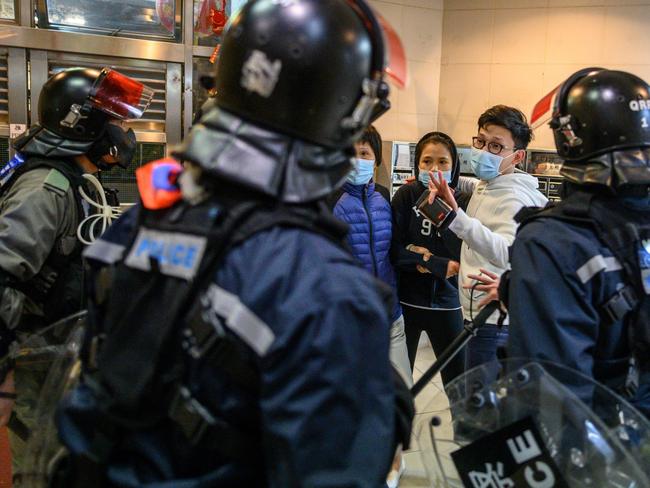 People argue with riot police in Hong Kong as residents protest against plans for an empty local housing estate to become a temporary virus quarantine camp. Picture: AFP