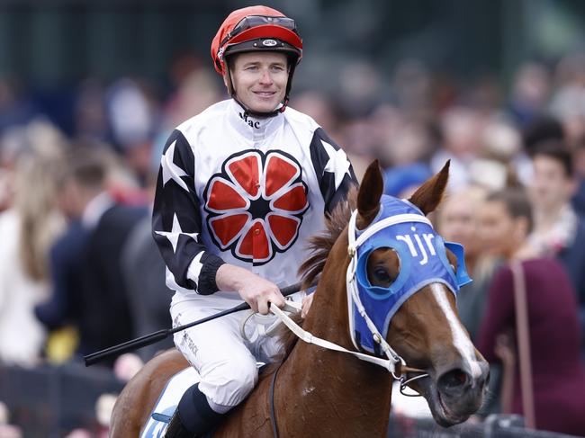 MELBOURNE, AUSTRALIA - NOVEMBER 03: Jamie McDonald returns to scale on Aitch Two Oh after winnin race 9 the Network 10 News Red Roses Stakes during 2022 Kennedy Oaks Day at Flemington Racecourse on November 03, 2022 in Melbourne, Australia. (Photo by Darrian Traynor/Getty Images)