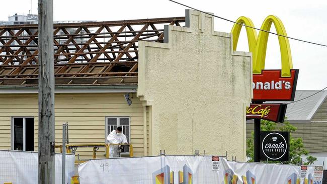 Workers remove the roof from the old firemans hall in Limestone Street in preparation for its demolition to extend the McDonald's carpark. Picture: Rob Williams