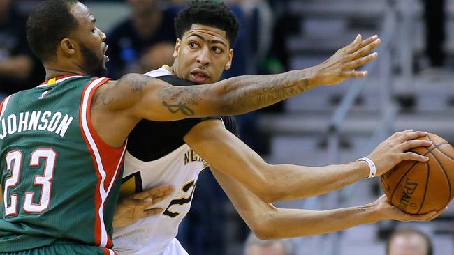 New Orleans Pelicans forward Anthony Davis, centre, drives against Milwaukee Bucks forward Chris Johnson.