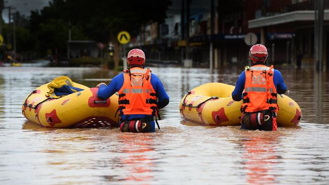 SES and police emergency crews move through the centre of Lismore looking for people in need of evacuation.