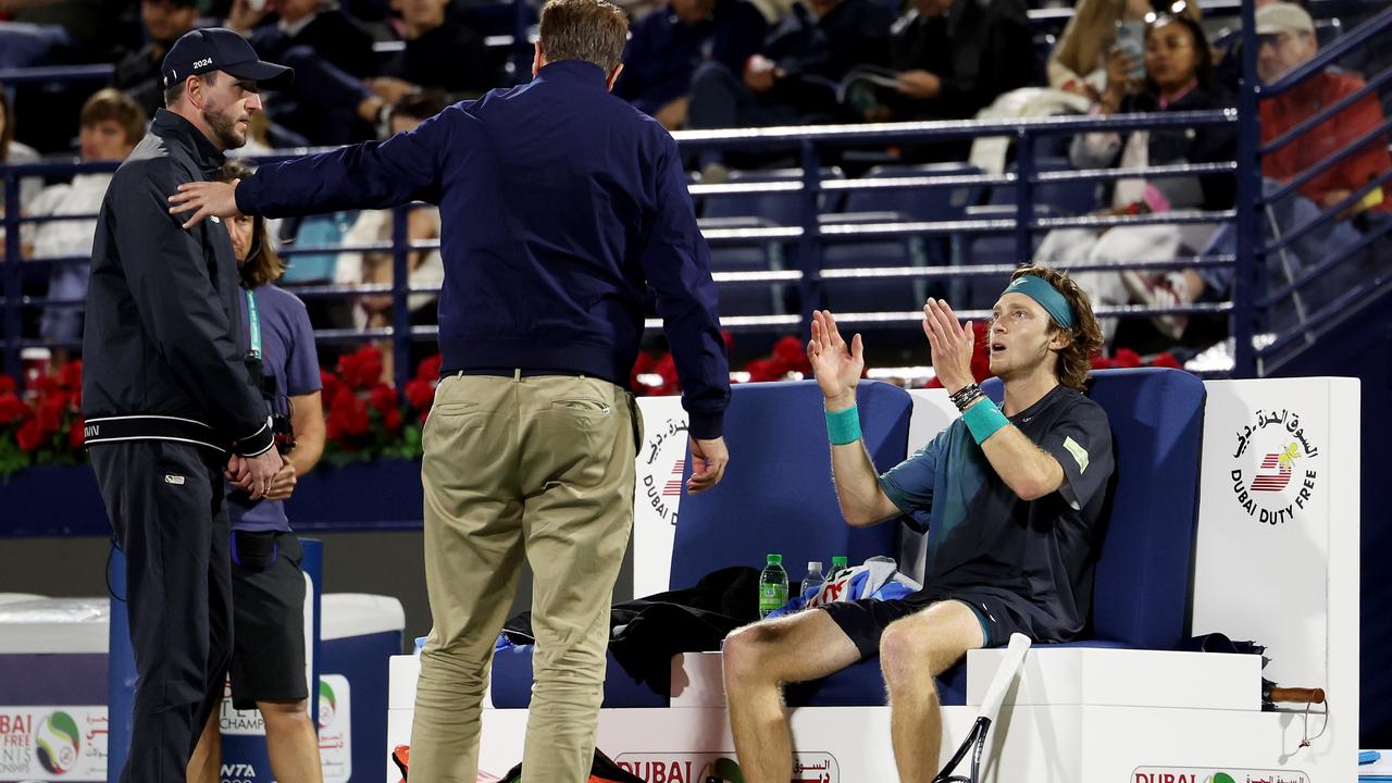 Andrey Rublev is dismissed by the court supervisor after shouting at a line judge. (Photo by Christopher Pike/Getty Images)