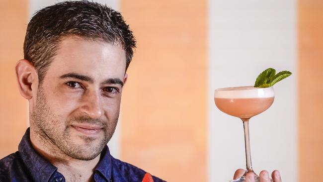 The Unley barman Nick Busse with the cocktail Pretty in Pink. Picture: AAP/Roy VanDerVegt