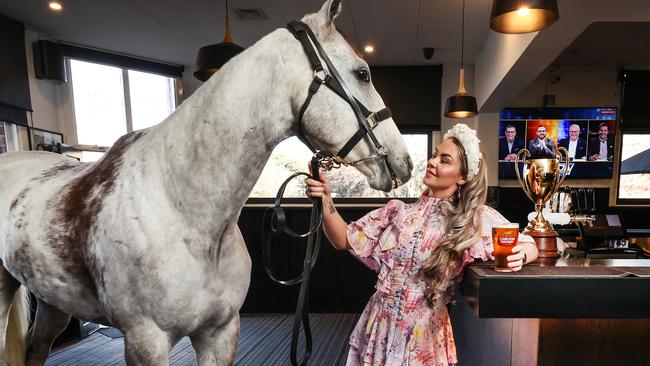 Trainer Gemma Rielly with former racehorse Archie having a Carlton Draught with the Caulfield Cup in The Emerald Hotel Sports Bar South Melbourne. Picture: David Caird