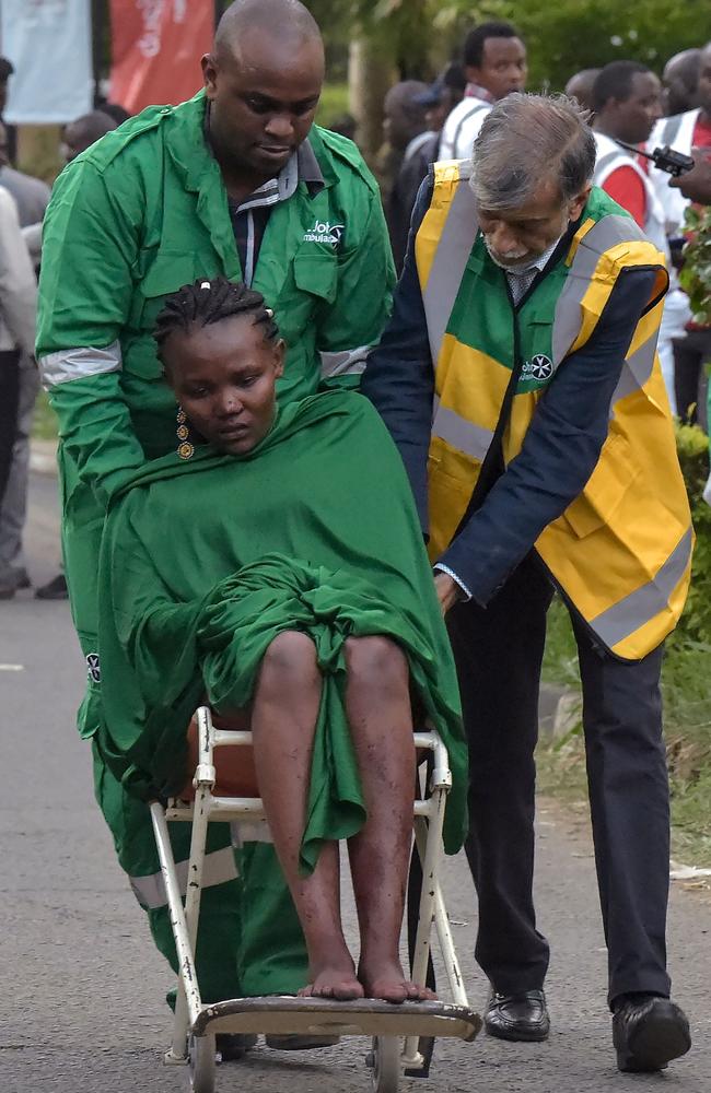 An injured woman is evacuated from the scene of an explosion at a hotel complex in Nairobi's Westlands suburb. Picture: Simon Maina/AFP