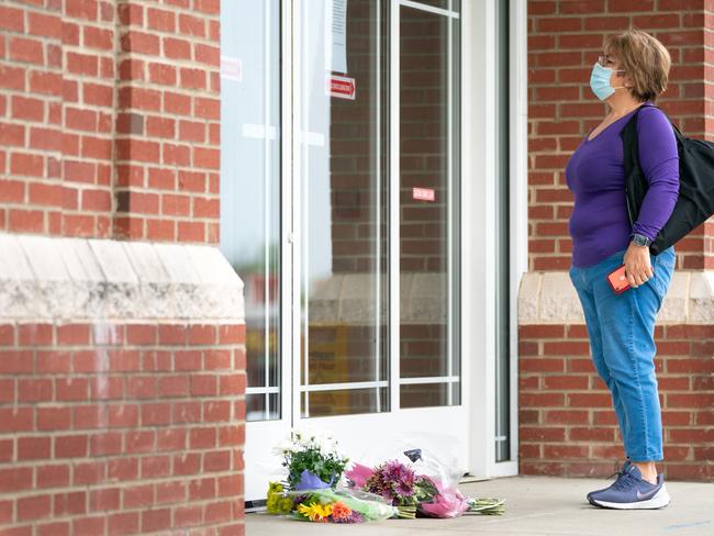 A woman reads a note explaining the temporary closure of Riverview Family Medicine after the fatal shooting of Dr. Robert Lesslie. AFP.