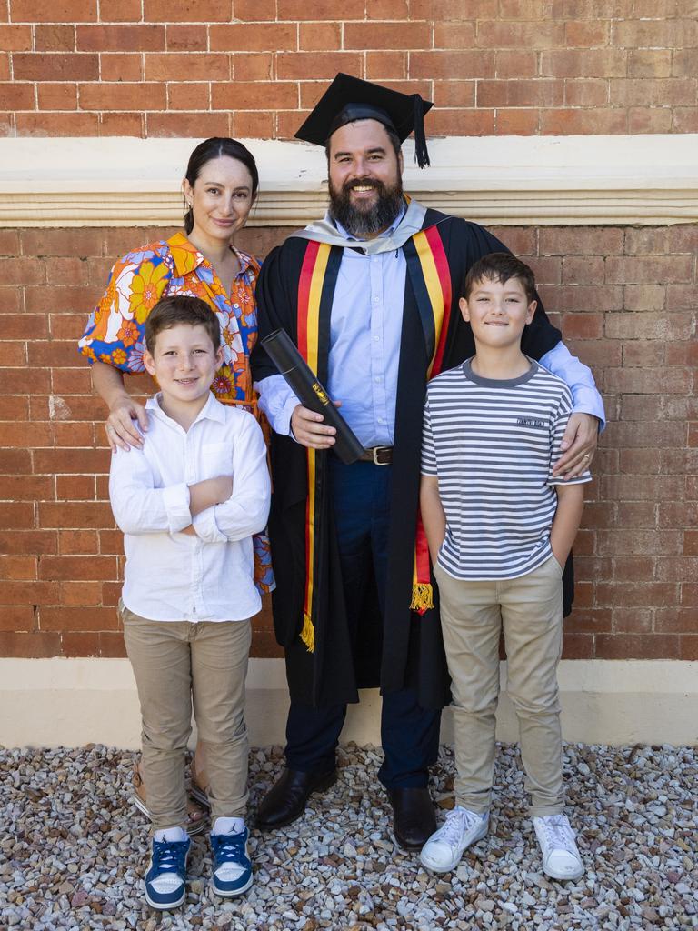 Caine Hanshaw celebrates his Master of Business Administration graduation with family Yasmine, Zavier (left) and Levi Hanshaw at the UniSQ graduation ceremony at Empire Theatres, Wednesday, December 14, 2022.