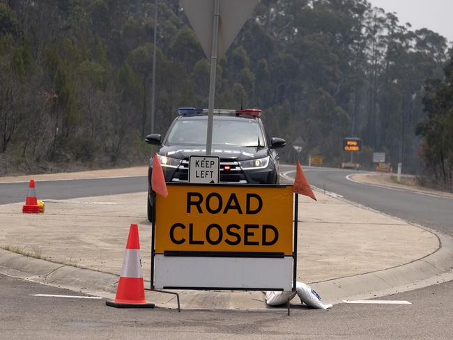 ORBOST, AUSTRALIA - JANUARY 10: Police road black is seen before Orbost as Firefighters along with the Australian Defence Force (ADF) brace for worsening bushfire conditions as State of Disaster is extended in Victoria on January 10, 2020 in Orbost, Australia. Victoria remains under a State of Disaster, which compels residents to evacuate if told to do so. The state remains on high bushfire alert with dangerous weather conditions forecast this afternoon. Three people died in the fires that swept across East Gippsland last week. More than 923,000 hectares have been burnt across Victoria, with hundreds of homes and properties destroyed.  (Photo by Luis Ascui/Getty Images)