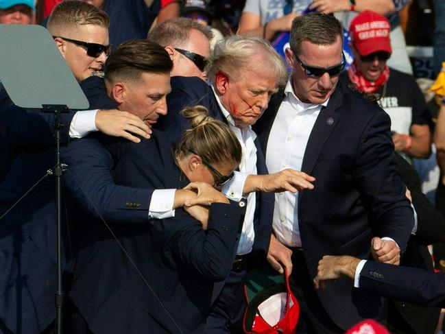 Secret Service agents helping Donald Trump off the podium after he was shot in Butler, Pennsylvania. Picture: Picture: AFP