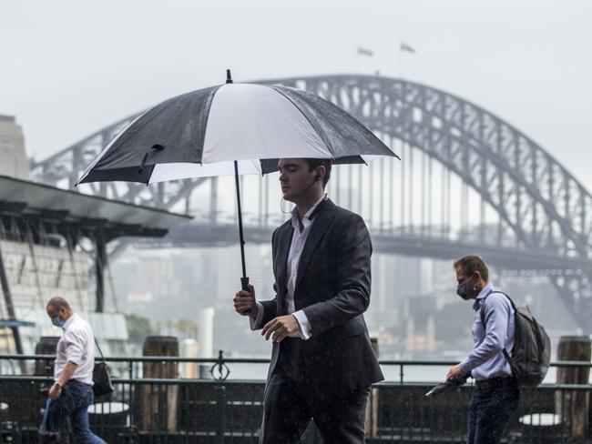 SYDNEY, AUSTRALIA - NewsWire Photos FEBRUARY 24:  Commuters pictured in the rain at Circular Quay after getting off a ferry.Picture: NCA NewsWire / Damian Shaw