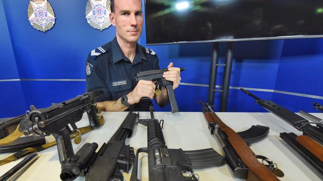 Leading Senior Constable Jon Bamford with an array of illegal guns. Picture: Tony Gough