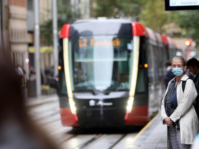 SYDNEY, AUSTRALIA - NewsWire Photos MAY 13, 2022:  People pictured waiting for the light rail on George Street in the Sydney CBD around 8am. Office worker numbers in the CBD on the rise.Picture: NCA NewsWire / Damian Shaw