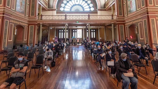 People wait for Covid-19 vaccinations at Melbourne’s Exhibition Building vaccination hub. Picture: Jason Edwards