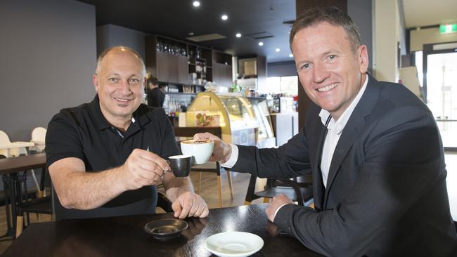 Margaret Brown’s son Shane shows his thanks to Olly and Me Cafe owner Michael Nemra for looking after his Mum. Picture: Melvyn Knipe