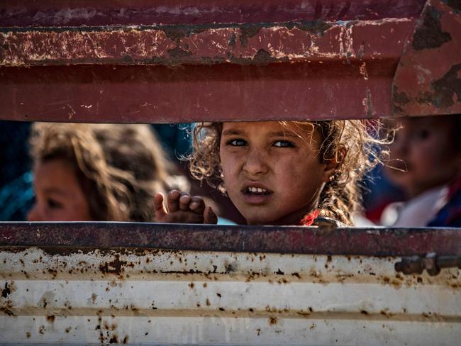 Syrian Arab and Kurdish civilians arrive to Tall Tamr town, in the Syrian northwestern Hasakeh province, after fleeing Turkish bombardment on the northeastern towns along the Turkish border on October 10, 2019. - Syria's Kurds battled to hold off a Turkish invasion on October 9 after air strikes and shelling launched a long-threatened operation that could reshape the country and trigger a humanitarian crisis. (Photo by Delil SOULEIMAN / AFP)