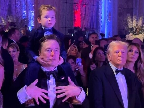 Elon Musk with his son on his shoulders stand alongside President-elect Donald Trump and Melania Trump (right) during Tuesday night's New Year's Eve party at Mar-a-Lago