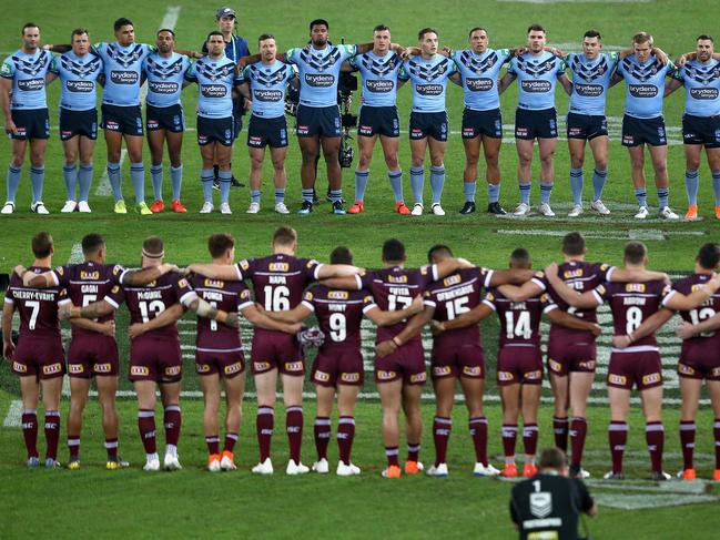 Both teams stand during the national anthem before game one of the 2019 State of Origin series.