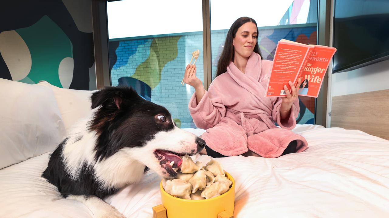 Border collie Cooper and his owner, Brigette Giarrusso, enjoying dog friendly dumplings at lyf Hotel Collingwood. Picture: David Caird