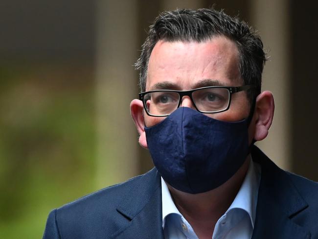 Victoria's state premier Daniel Andrews wears a mask as he arrives at a press conference in Melbourne on July 22, 2020. - Australia reported a record 501 new COVID-19 coronavirus infections on July 22, nearly four months after the pandemic initially peaked in the country, with authorities warning of a critical new phase in its two biggest cities. (Photo by William WEST / AFP)