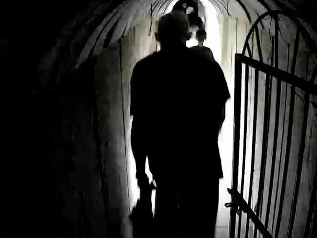 This image grab from a handout video released by the Israeli army on February 13, 2024, shows what the army says is Hamas's chief in Gaza Yahya Sinwar, walking in a tunnel along with other people, in the Gaza Strip amid ongoing battles between Israel and the Palestinian militant group Hamas. Israel's army released a video it said was of Sinwar, filmed on October 10, 2023 with his family members in a tunnel in the Palestinian territory. The black and white images showing a man said to be the Hamas chief being led through a tunnel together with a woman and three children are said to be the first of him since the Israel-Hamas war broke out. (Photo by Israeli Army / AFP) / === RESTRICTED TO EDITORIAL USE - MANDATORY CREDIT "AFP PHOTO / Handout / Israeli Army' - NO MARKETING NO ADVERTISING CAMPAIGNS - DISTRIBUTED AS A SERVICE TO CLIENTS ==