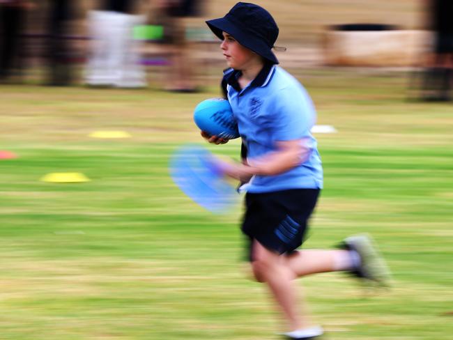 11-year-old Cody Vostinar from York Public School takes a run at a sports clinic in  South Penrith where the Active Kids Rebate was launched.