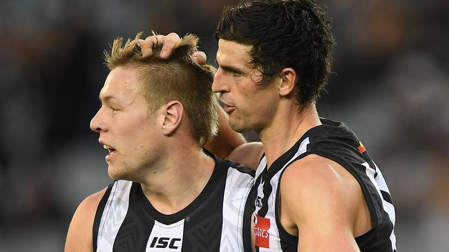 Jordan de Goey and Scott Pendlebury celebrate a goal for the Magpies. Picture: AAP Images