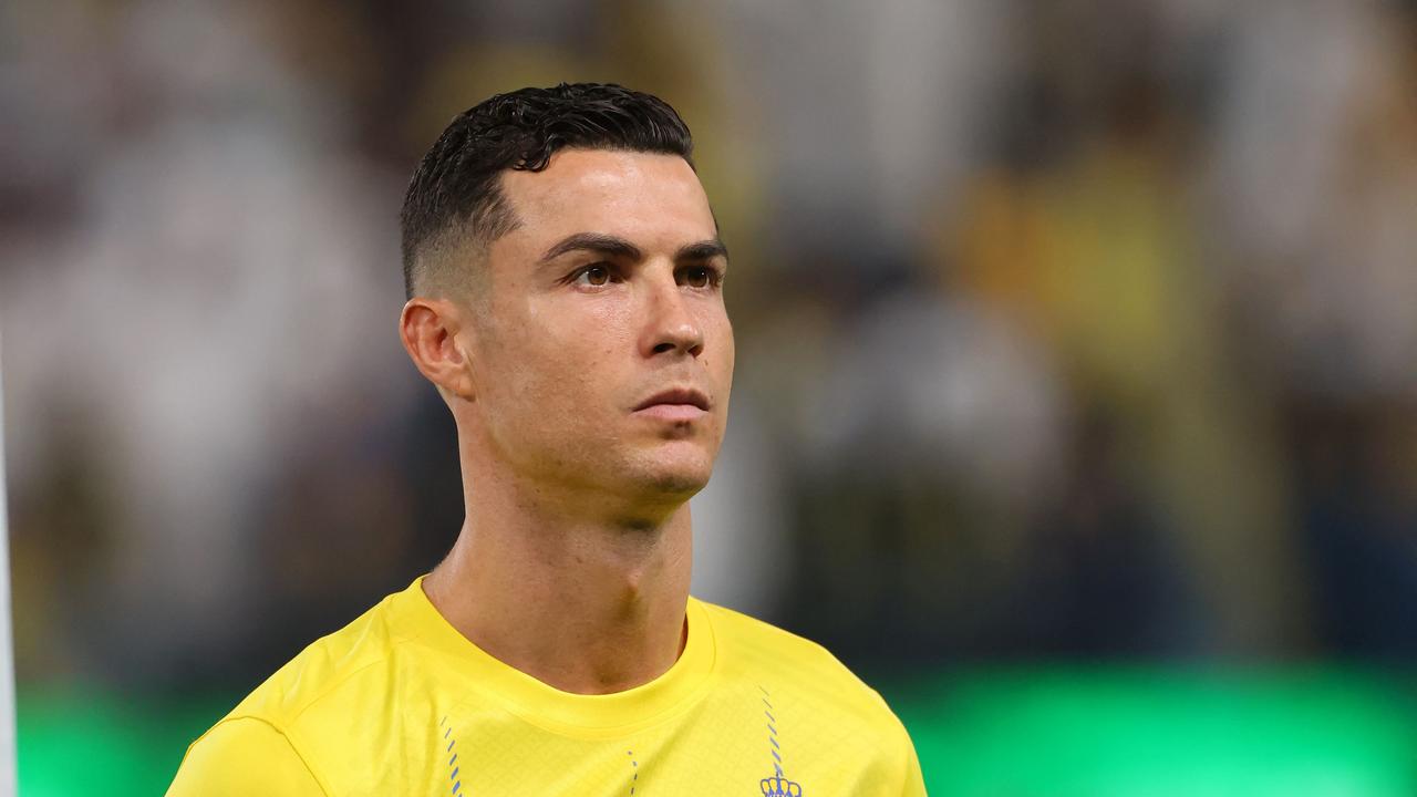 Nassr's Portuguese forward #07 Cristiano Ronaldo stands in line for the national anthems ahead of the Saudi Pro League football match between Al-Nassr and Abha at the King Saud University Stadium in Riyadh on October 6, 2023. (Photo by Fayez NURELDINE / AFP)