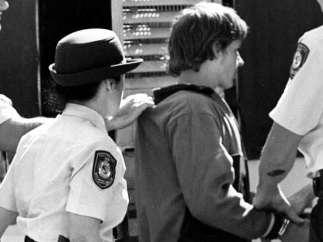 SEPTEMBER 12, 1988: Carol Arrow aged 18 [LEFT] and Wayne Wilmot [right] are escoreted by police at Campbelltown Court, 12/09/88, where they faced charges relating to the murder of Janine Balding. Pic Uwe Kuessner. NSW / Crime / Murder Historical