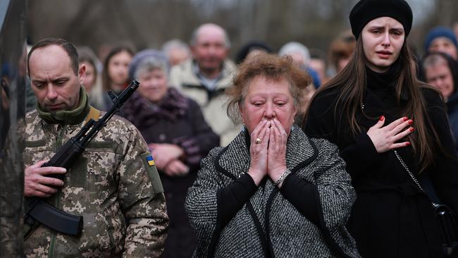 Maria Korechko, centre, mourns at the burial for her son, Ukrainian soldier Andriy Zagornyakon, in Kamianka-Buzka on Sunday local time. Zagornyakon died fighting the Russian military near the town of Popasny. Picture: Getty Images