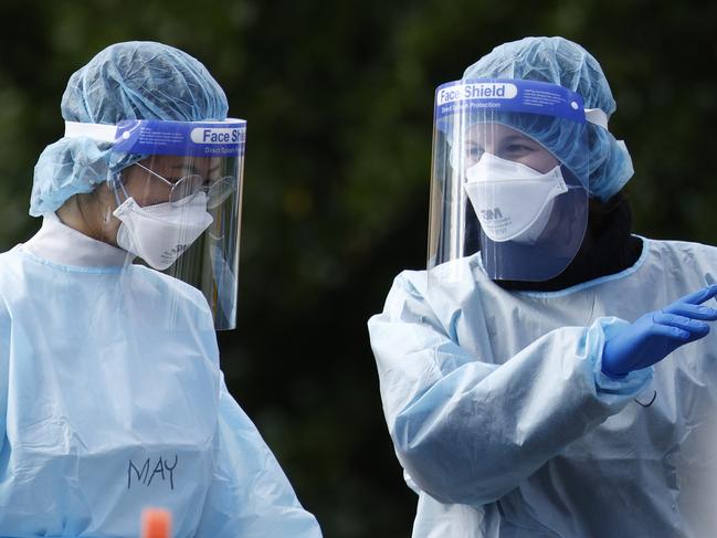 MELBOURNE, AUSTRALIA - NewsWire Photos AUGUST 20, 2021: Health workers are seen speaking at the COVID testing centre next to the Palais Theatre at St Kilda. Picture: NCA NewsWire / Daniel Pockett