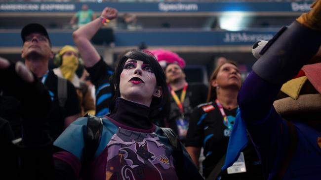 A woman dressed as a Fortnite character reacts during the final seconds of the Duos competition. Picture: AFP