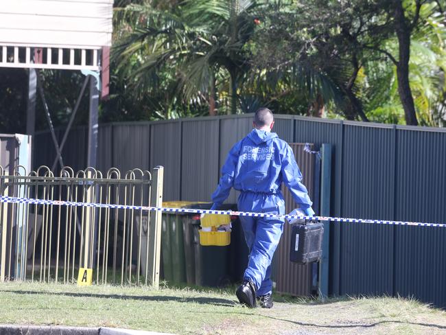 Forensic officers entering the Beachcomber Ave property.