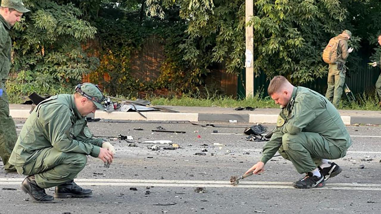 Investigators work on the place of explosion of a car driven by Darya Dugina, daughter of Alexander Dugin, a hard line Russian ideologue close to President Vladimir Putin, outside Moscow. (Photo by Handout / Investigative Committee of Russia / AFP)