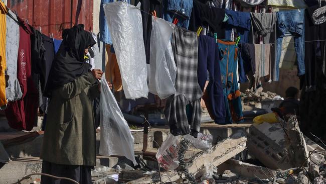 A displaced Palestinian woman hanging laundry amid the rubble of a damaged house in the Rafah refugee camp in the southern Gaza Strip. Picture: AFP