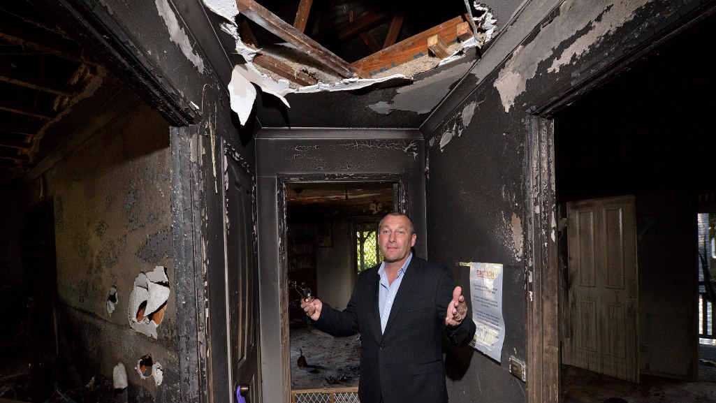 DAMAGE CONTROL: Agent Steve Venn in the house that will go to auction after being severely damaged by fire. Picture: John Mccutcheon