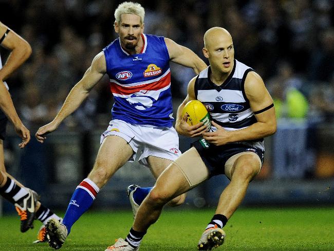 Geelong v Western Bulldogs. Etihad Stadium. Gary Ablett Jr turns Jason Akermanis inside out. Picture: Colleen Petch