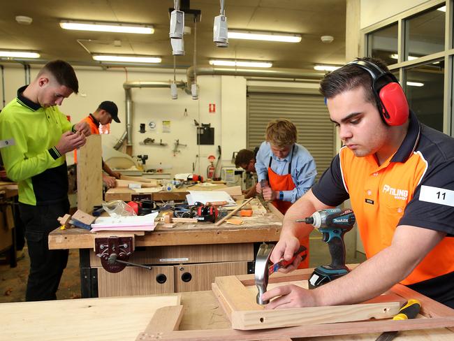 Students (L-R) Jasper Dryden, Max Coleman and Joseph Campisi represent host school Champagnat College Pagewood for the Worldskills Construction Competition at their TradeTraining facility in Sydney on Wednesday 30, 2017. Many students from schools around the region also participate.(Jane Dempster/AAP).