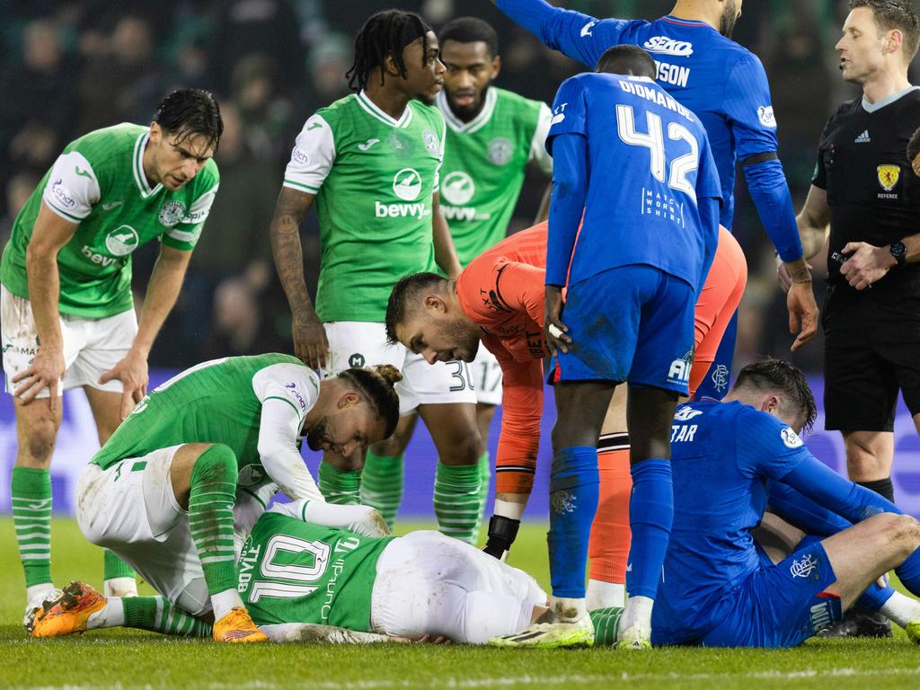 Players gather around the hurt Socceroo. Picture: Getty Images