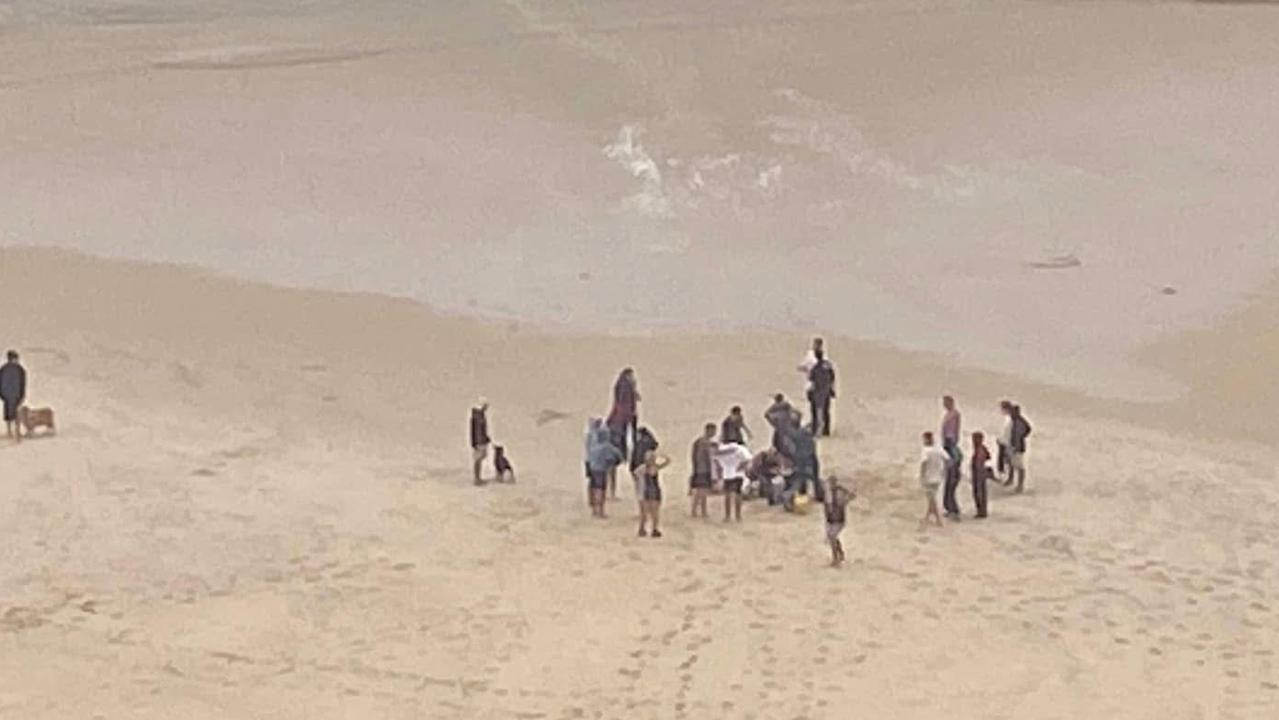 The man was spotted in the water at Palm Beach about 5.15pm and brought to shore by onlookers who desperately performed CPR before paramedics arrived.