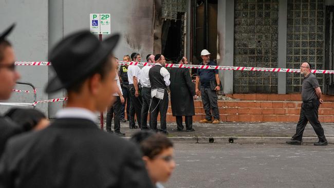 Members of the local Jewish community look at the damage of the arson attack at Melbourne’s Adass Israel Synagogue. Picture: Getty